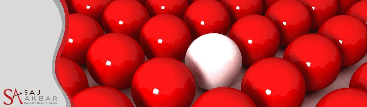 Lots of red snooker balls and a white one in the middle