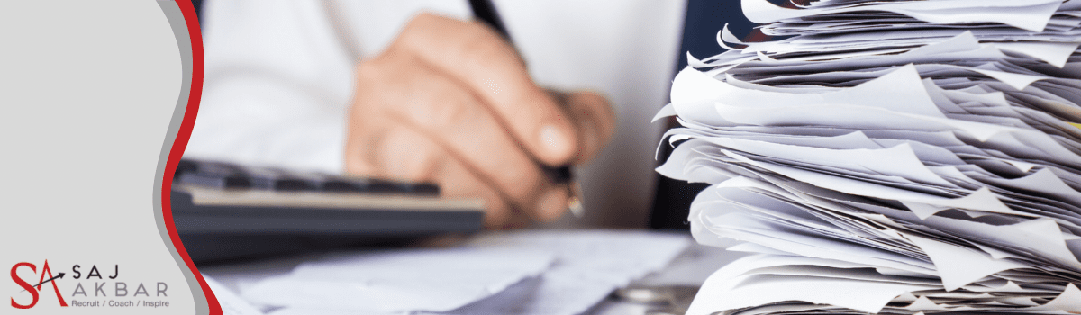 Someone working on a mound of paperwork