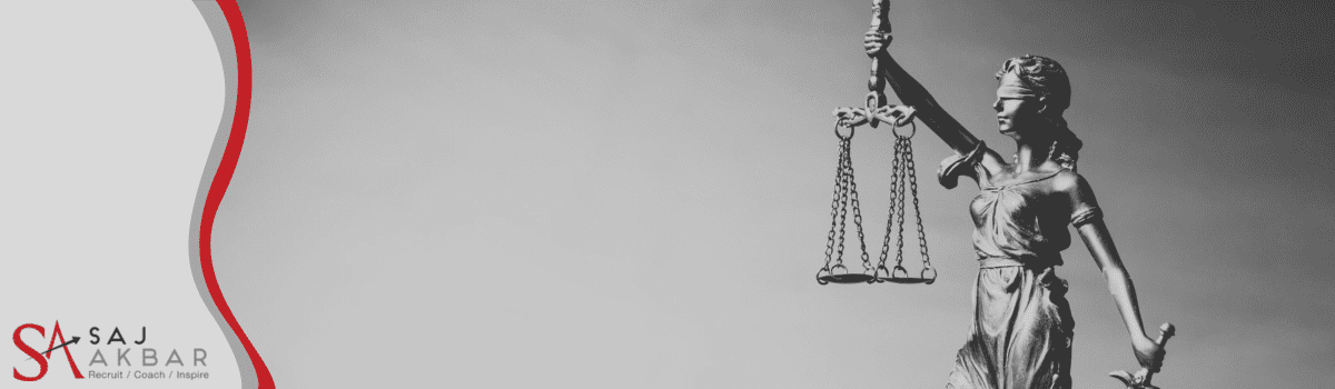 A statue of a woman holding up some scales