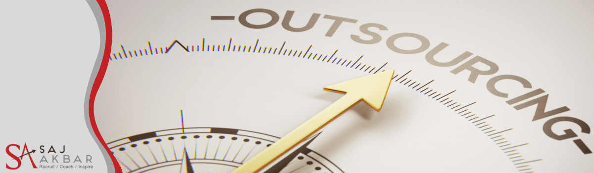 A compass needle pointing towards the word outsourcing 