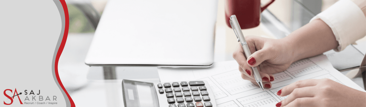 Someone sat at a desk with a calculator 